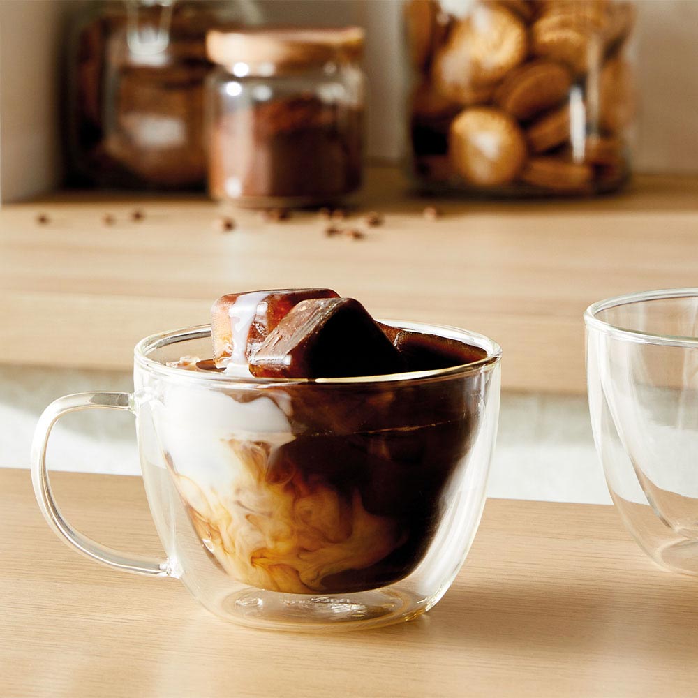 A glass cup filled with dark amber tea transparent beverage container - Baccarat barista brillante