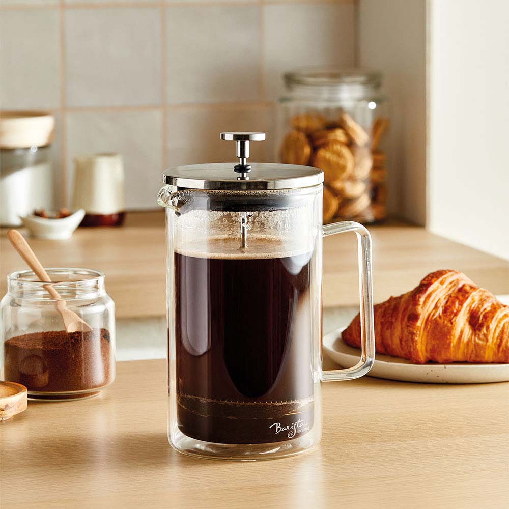 A clear Baccarat Double-Wall Coffee Press pitcher with a side handle perfect for serving beverages