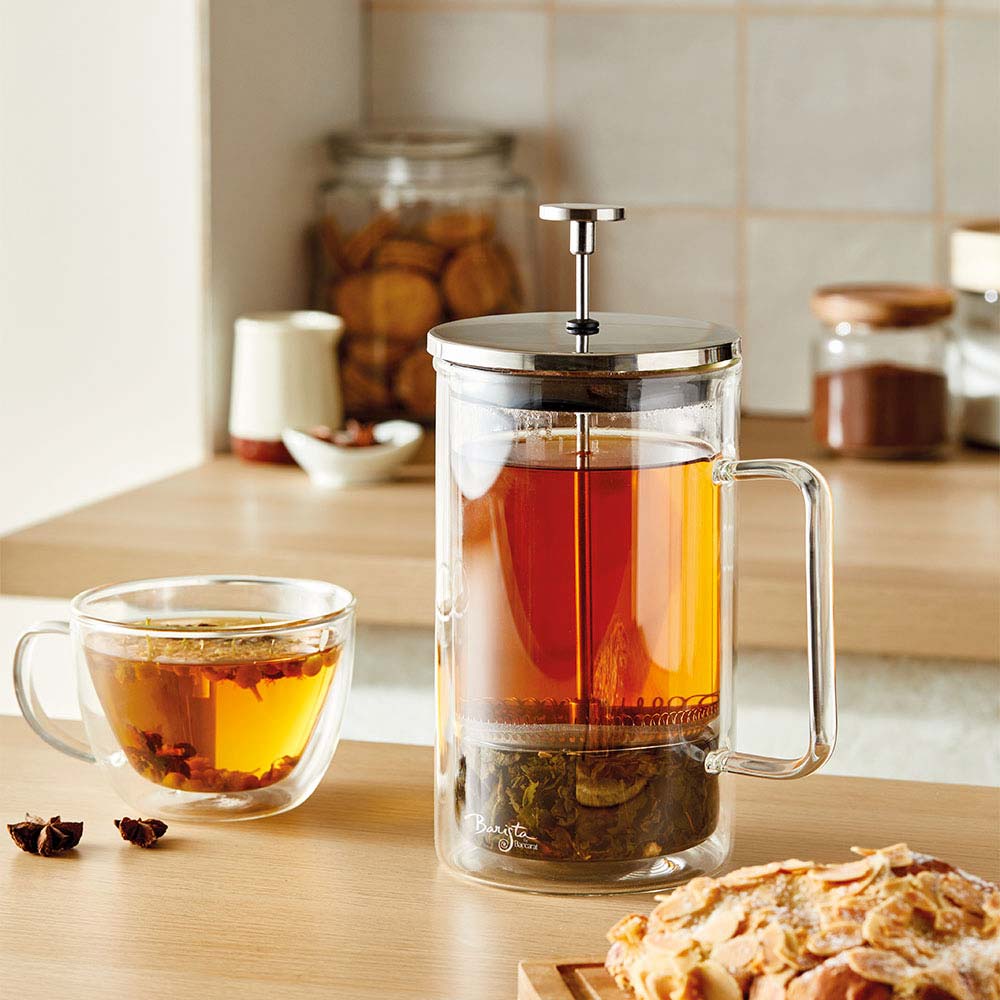 A clear Baccarat Double-Wall Coffee Press pitcher with a side handle perfect for serving beverages