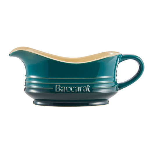 A teal ceramic gravy boat with a cream interior featuring a side handle teal gravy boat - Barista