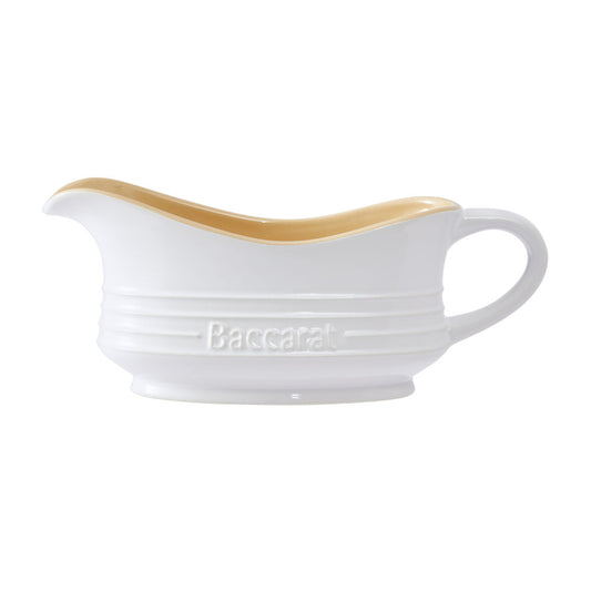 A white ceramic gravy boat with a light brown interior featuring an elegant handle design - Baccarat