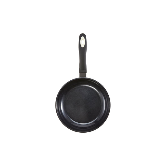 A creamy risotto with green peas in a white pan on a wooden board - cream bio frypan 20cm - Baccarat