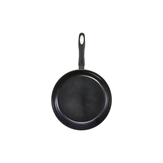 A 32-cm Baccarat  Bio Frying pan containing pasta on a wooden board surrounded by fresh ingredients