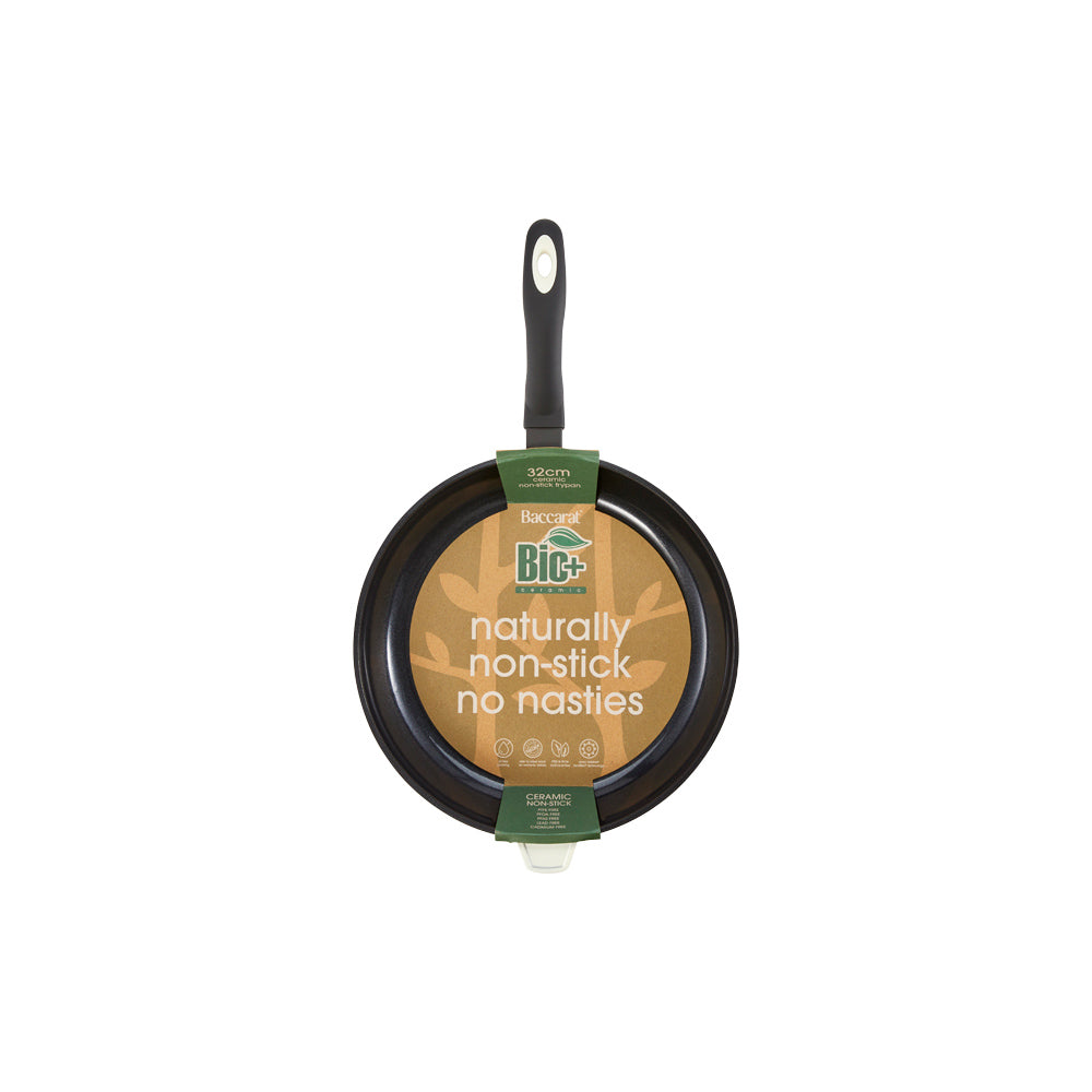 A 32-cm Baccarat  Bio Frying pan containing pasta on a wooden board surrounded by fresh ingredients