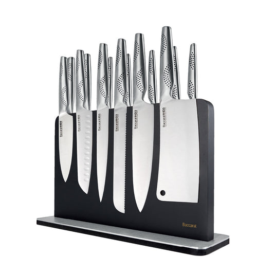 A close-up of a silver stainless steel knife on a wooden cutting board stainless steel knife - Kachi