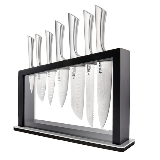Close-up of Baccarat Damashiro Satori kitchen knife with a patterned blade on a grey countertop 