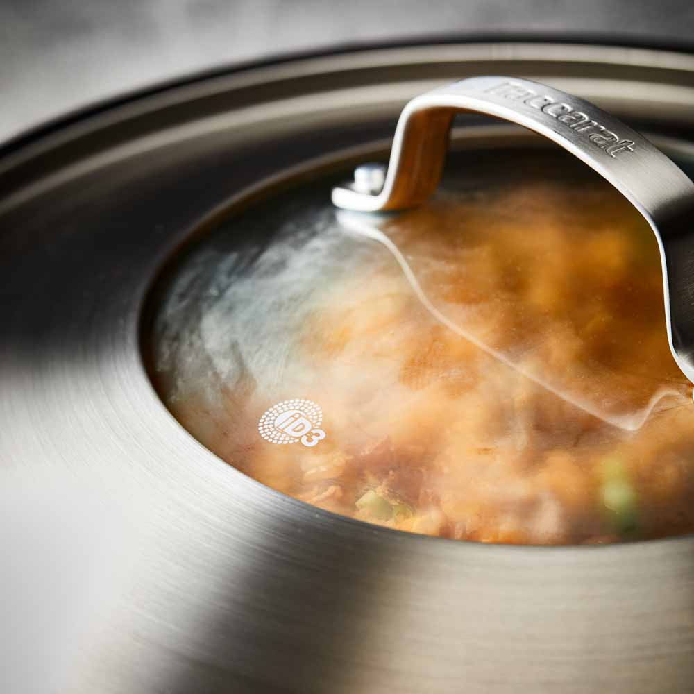 Person serving gourmet pasta from a black bowl - Baccarat id3 stainless steel chef pan with lid 32cm