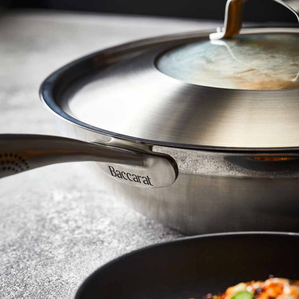 Person serving gourmet pasta from a black bowl - Baccarat id3 stainless steel chef pan with lid 32cm
