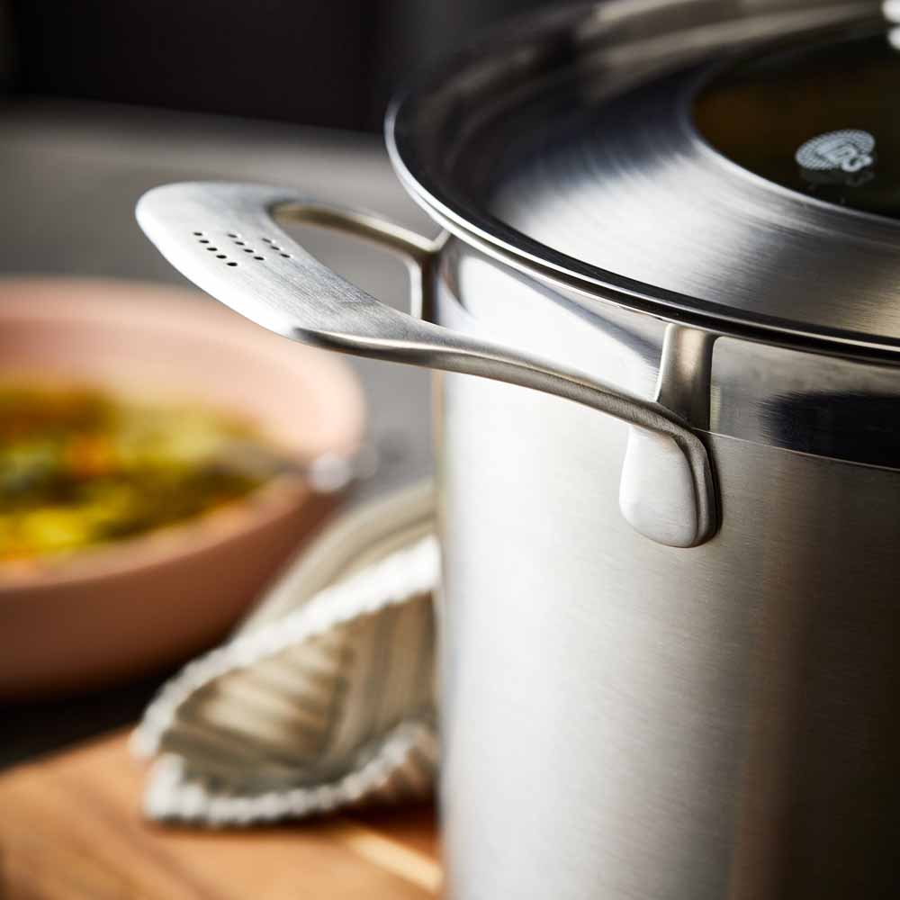Close-up of a stainless steel pot lid with a handle and steam holes modern cookware 24cm - Baccarat