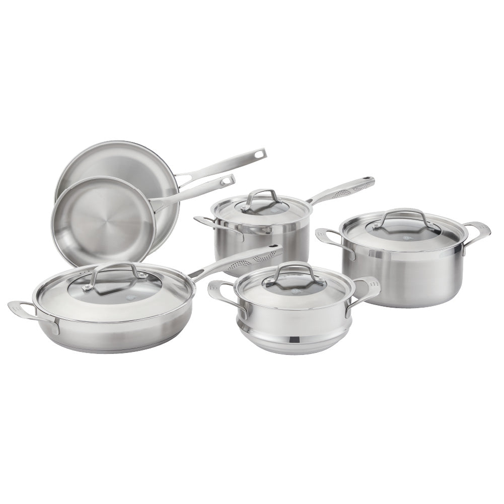 Five stainless steel cookware pieces with vegetables on a kitchen counter 24cm stockpot - Baccarat
