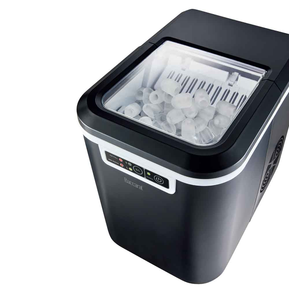 Close-up of the Baccarat The Ultimate Frost Ice Cube Maker with ice cubes and white control buttons 