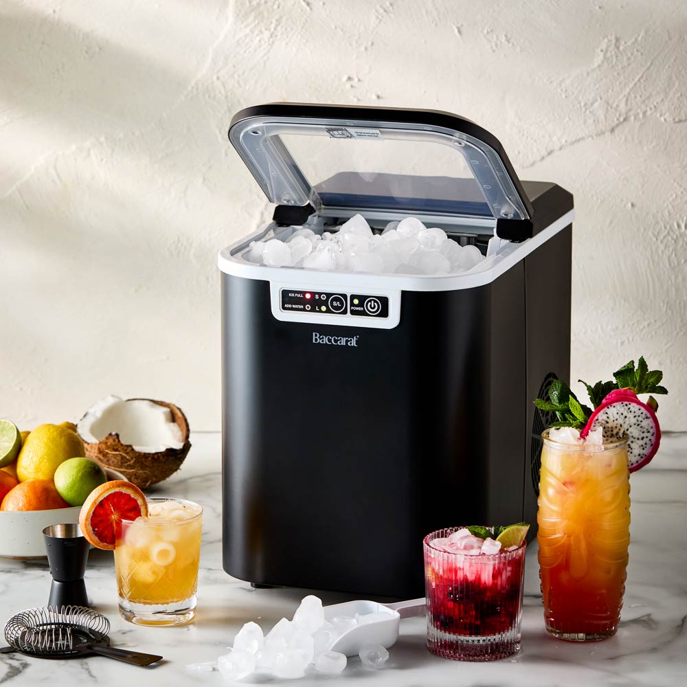 Close-up of the Baccarat The Ultimate Frost Ice Cube Maker with ice cubes and white control buttons 