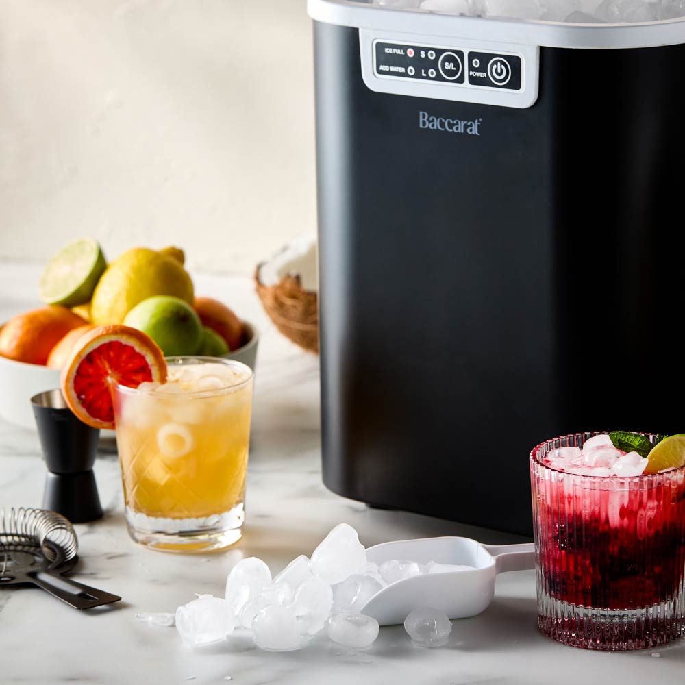 Close-up of the Baccarat The Ultimate Frost Ice Cube Maker with ice cubes and white control buttons 