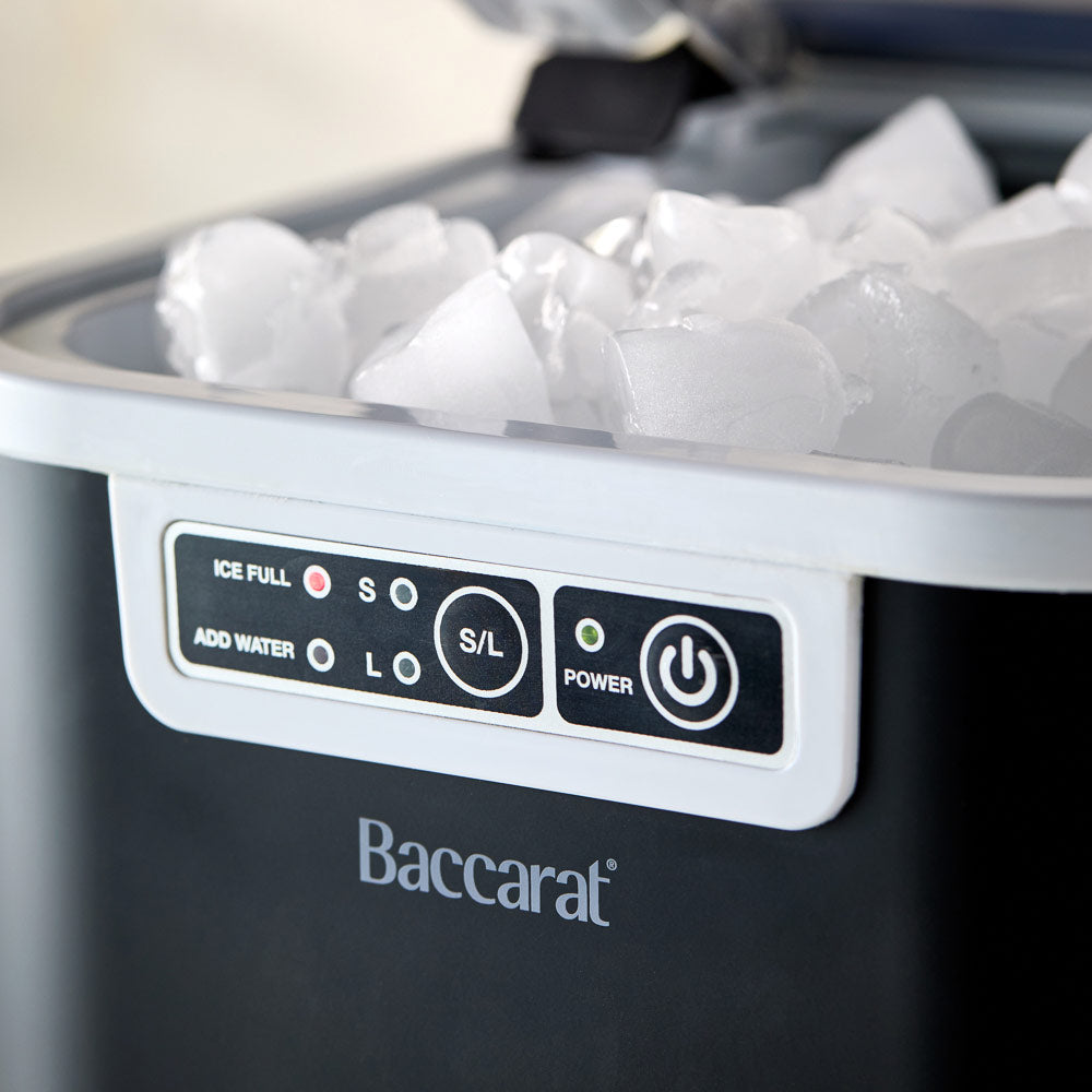 Close-up of the Baccarat The Ultimate Frost Ice Cube Maker with ice cubes and white control buttons 