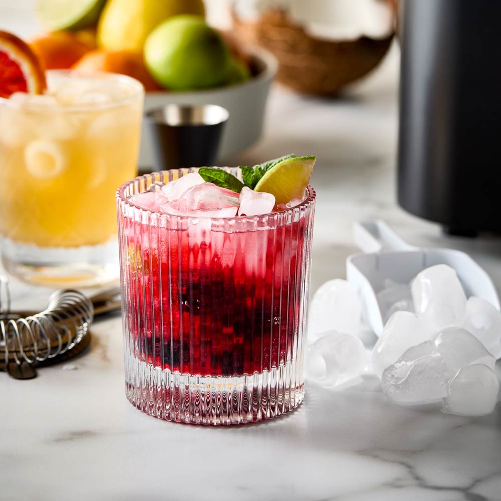 Close-up of the Baccarat The Ultimate Frost Ice Cube Maker with ice cubes and white control buttons 