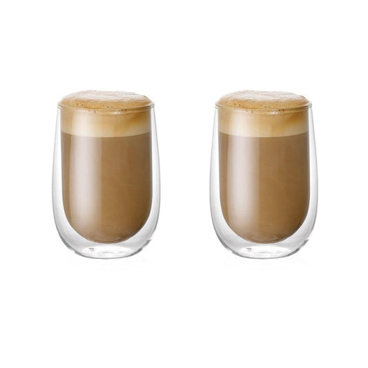 hot coffee in double-walled glass mug on wooden plate with spoon next to empty glass - Baccarat