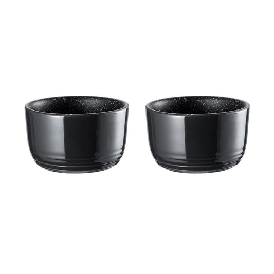 two small ramekins filled with a breakfast of eggs tomatoes greens and beans - Baccarat stone