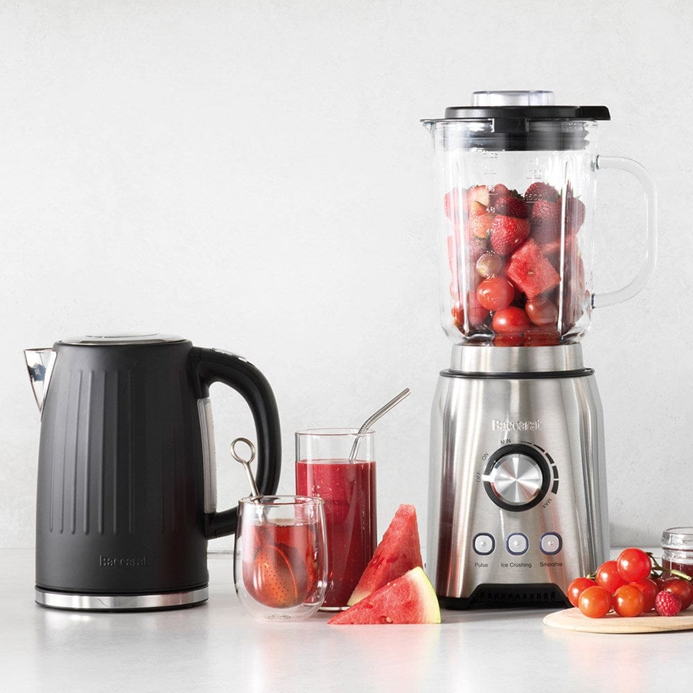 Black kettle pours hot water into a white cup beside a pastry plate - Baccarat  Boiling Point Kettle