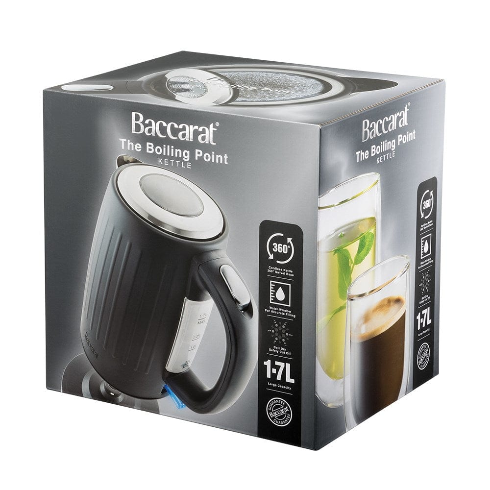 Black kettle pours hot water into a white cup beside a pastry plate - Baccarat  Boiling Point Kettle