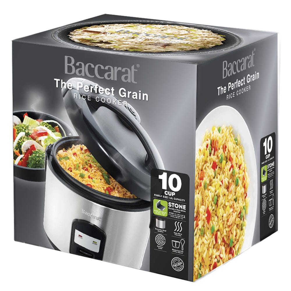 A person opening a silver rice cooker on a kitchen counter next to a bowl of veggies- Baccarat