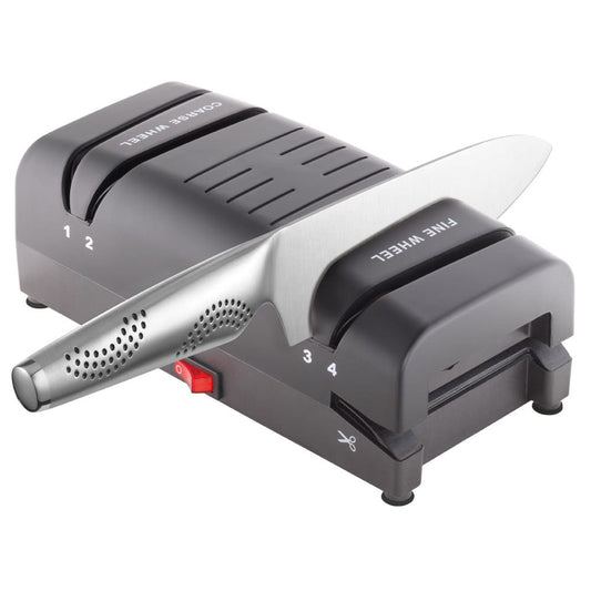 Electric knife sharpener on kitchen counter next to sliced mangoes black knife sharpener - Baccarat
