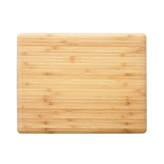 Bamboo chopping board in natural colour with clean white plates and utensils - Baccarat